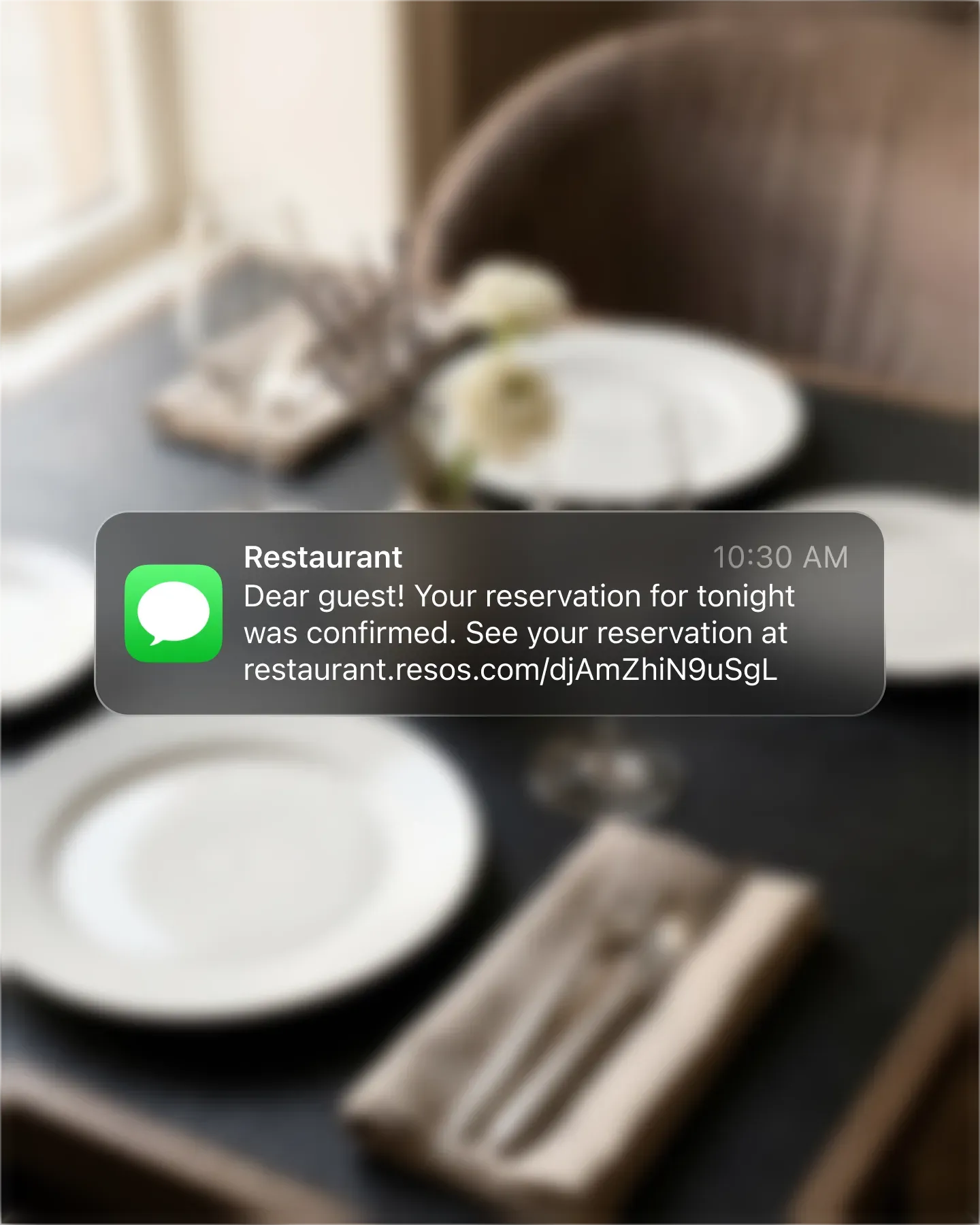 Booking confirmation SMS with a reservation link on a guest's phone