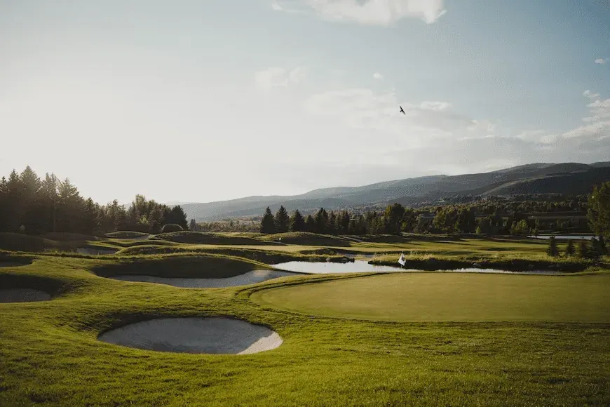 Golfbane med bjerge i baggrunden.