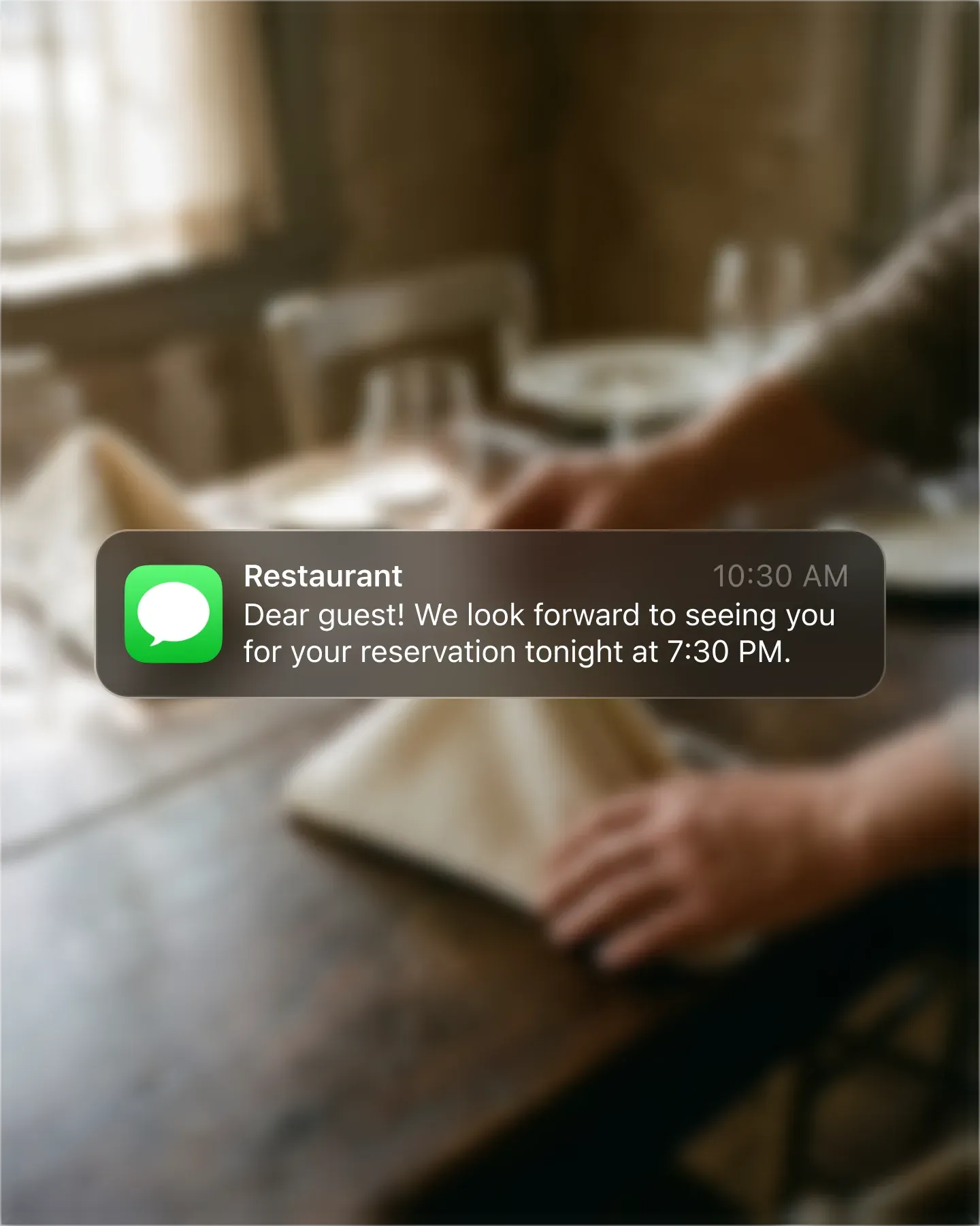 SMS booking reminder from the restaurant on a guest's phone lock screen