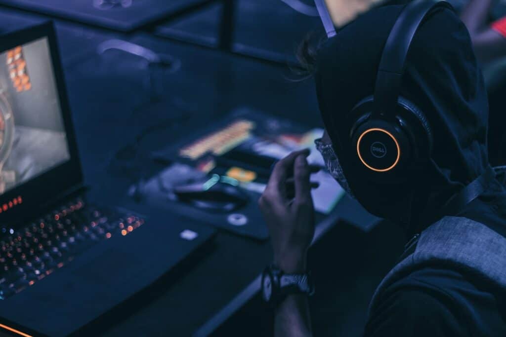 Guy playing computer games in a gaming café. 