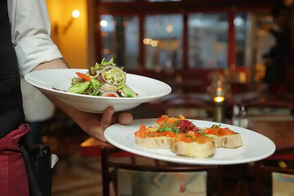 Waiter serving food