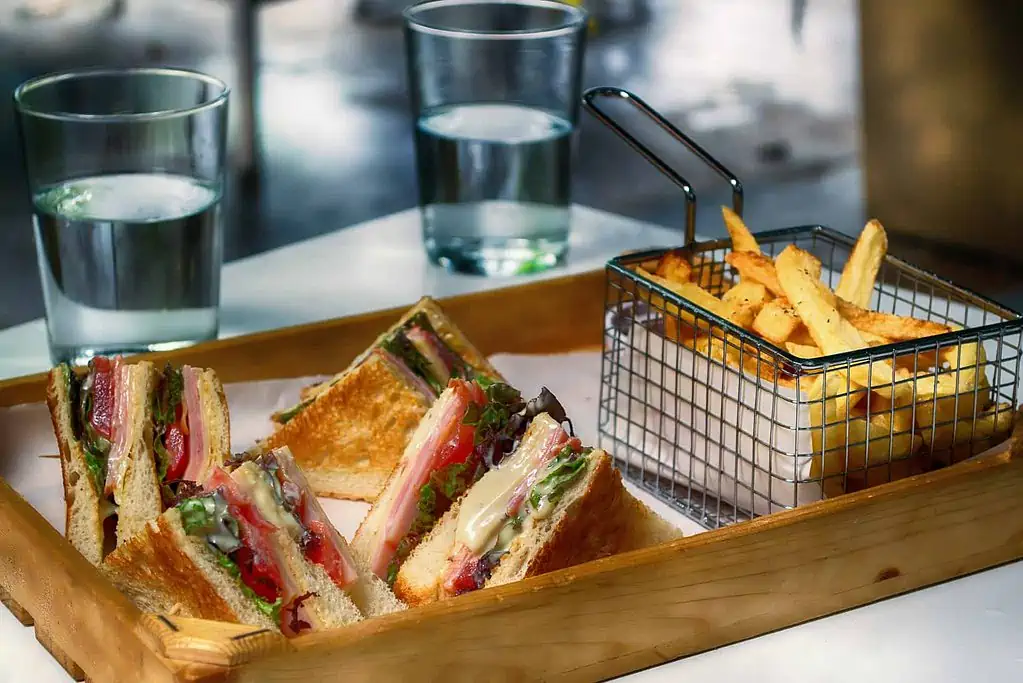 Club Sandwich and fries and water
