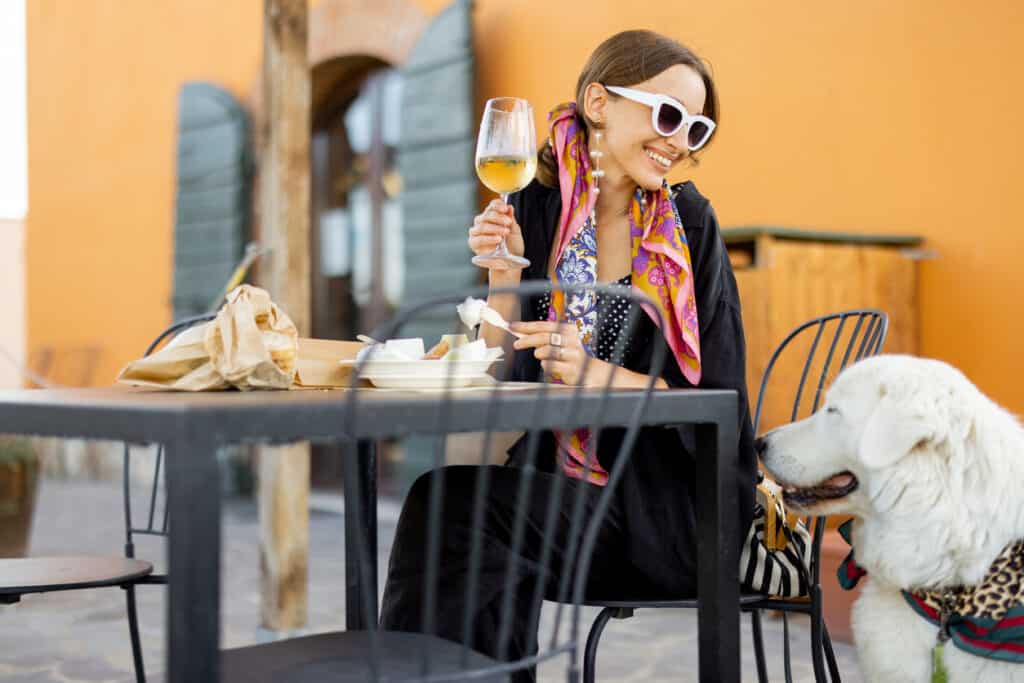 Woman eating a lunch with the dog