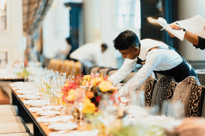 Waiter preparing table at a luxury restaurant.